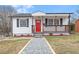Charming single-story home featuring a welcoming porch and well-maintained front yard with a red front door at 318 Fulton St, Burlington, NC 27217