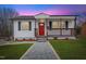 Charming single-story home featuring a welcoming porch and well-maintained front yard with a red front door at 318 Fulton St, Burlington, NC 27217