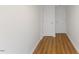 Hallway with wood-look flooring leading to two white paneled doors at 318 Fulton St, Burlington, NC 27217
