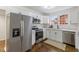Fully-equipped kitchen with stainless steel appliances, white cabinets, and a stylish countertop at 318 Fulton St, Burlington, NC 27217