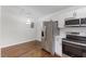 Kitchen featuring stainless steel appliances, ample counter space, and stylish pendant lighting at 318 Fulton St, Burlington, NC 27217