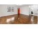 Spacious living area boasts gleaming hardwood floors and leads to an adjacent bathroom at 318 Fulton St, Burlington, NC 27217
