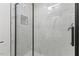 Close-up of a modern shower with white marble tile and sleek hardware at 318 Fulton St, Burlington, NC 27217