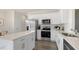Bright kitchen featuring white cabinets, stainless steel appliances, and a large island with seating at 399 Saddle Mare St, Clayton, NC 27520