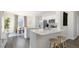 Modern kitchen featuring white cabinets, stainless steel appliances, a quartz countertop, and a breakfast bar at 399 Saddle Mare St, Clayton, NC 27520
