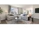 Spacious living room showcasing a large sectional sofa, stylish rug, and contemporary decor at 399 Saddle Mare St, Clayton, NC 27520
