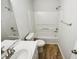 Bright bathroom featuring a vanity, toilet, and tub-shower combination at 4205 Rockside Hills Dr, Raleigh, NC 27603
