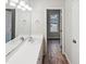 Bright bathroom featuring a double sink vanity, large mirror and a view to the outside at 4205 Rockside Hills Dr, Raleigh, NC 27603