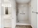 Accessible bathroom featuring a walk-in shower, safety bars, neutral walls, and a view of the vanity at 4205 Rockside Hills Dr, Raleigh, NC 27603