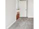 Neutral bedroom with gray carpet and a view of a hallway with gleaming hardwood floors at 4205 Rockside Hills Dr, Raleigh, NC 27603