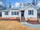Charming single-story home with a brick foundation, manicured lawn, and inviting front entrance at 4205 Rockside Hills Dr, Raleigh, NC 27603
