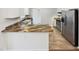 Well-lit kitchen with white cabinets, granite countertops, stainless steel appliances, and modern flooring at 4205 Rockside Hills Dr, Raleigh, NC 27603