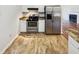 Bright kitchen featuring stainless steel appliances, granite countertops, and white cabinets at 4205 Rockside Hills Dr, Raleigh, NC 27603