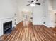 Spacious and bright living room featuring wood floors and fireplace, open floor plan with dining area at 4205 Rockside Hills Dr, Raleigh, NC 27603