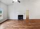 Spacious living room with hardwood floors, a fireplace with a black hearth, and bright white walls at 4205 Rockside Hills Dr, Raleigh, NC 27603