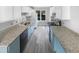 Galley kitchen featuring sleek countertops, stainless steel appliances, and ample cabinet space at 4213 Sunscape Ln, Raleigh, NC 27613