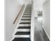 Stairway with wooden handrail leading to open living space at 4213 Sunscape Ln, Raleigh, NC 27613