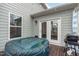 Backyard patio with a hot tub, grill, and access door to the house at 464 Granite Saddle Dr, Rolesville, NC 27571