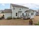 Exterior view of the backyard featuring a deck, patio seating, and a well-maintained lawn at 464 Granite Saddle Dr, Rolesville, NC 27571