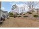 Large backyard with a fire pit, grassy area, and a deck with outdoor furniture at 464 Granite Saddle Dr, Rolesville, NC 27571