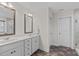 Bathroom features a dual sink vanity, granite countertop, and framed mirrors at 464 Granite Saddle Dr, Rolesville, NC 27571
