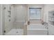Bathroom offers a walk-in shower and a soaking tub beside a window at 464 Granite Saddle Dr, Rolesville, NC 27571