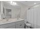 Bathroom with double sink vanity, large mirror, and a shower with a white curtain at 464 Granite Saddle Dr, Rolesville, NC 27571