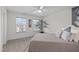 Bright bedroom with neutral walls, ceiling fan, and a decorative plant near the sunny windows at 464 Granite Saddle Dr, Rolesville, NC 27571