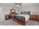 Bedroom with a ceiling fan, wooden furniture, and carpet flooring, creating a comfortable space at 464 Granite Saddle Dr, Rolesville, NC 27571