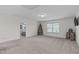 Spacious bonus room featuring neutral carpet and a large window allowing ample natural light at 464 Granite Saddle Dr, Rolesville, NC 27571
