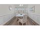 Bright dining room featuring modern decor, wainscoting, and ample natural light at 464 Granite Saddle Dr, Rolesville, NC 27571