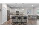 Modern kitchen with granite countertops, stainless steel appliances, and island seating at 464 Granite Saddle Dr, Rolesville, NC 27571