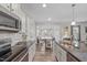 Open kitchen with stainless appliances, granite counters, and view to living area at 464 Granite Saddle Dr, Rolesville, NC 27571