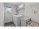 This laundry room features a utility sink, laundry machines, and overhead storage at 464 Granite Saddle Dr, Rolesville, NC 27571