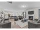 Open-concept living area with fireplace adjacent to kitchen with island seating at 464 Granite Saddle Dr, Rolesville, NC 27571