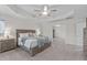 Large bedroom with a tray ceiling, ceiling fan, and ensuite access at 464 Granite Saddle Dr, Rolesville, NC 27571