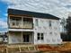 New two-story house under construction with a back deck and balcony at 49 Golden View Pl, Zebulon, NC 27597