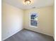 Cozy bedroom with neutral walls and carpets, with view of neighborhood at 5107 Tomasita Ct, Raleigh, NC 27616