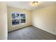 Bedroom with neutral color scheme and a large window overlooking the neighborhood at 5107 Tomasita Ct, Raleigh, NC 27616