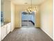 Bright dining area features a sliding glass door to the outdoor patio and modern chandelier at 5107 Tomasita Ct, Raleigh, NC 27616
