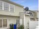 View of the exterior with an attached patio with sliding glass doors and a satellite dish at 5107 Tomasita Ct, Raleigh, NC 27616