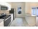 Kitchen featuring stainless steel appliances, white cabinets and an eat-in island at 5107 Tomasita Ct, Raleigh, NC 27616