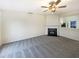 Cozy living room features a fireplace, neutral carpet and a breakfast bar overlooking the kitchen at 5107 Tomasita Ct, Raleigh, NC 27616