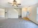 A living room with gray carpet and stairs that lead to the second floor at 5107 Tomasita Ct, Raleigh, NC 27616