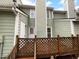 Exterior of the house features green siding, a wooden deck, and clear views at 516 Caprice Ct, Raleigh, NC 27606
