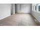 Spacious bedroom with lots of natural light, neutral carpet and access to closets at 516 Caprice Ct, Raleigh, NC 27606