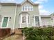 Charming multi-story townhouse with light green siding and updated windows at 516 Caprice Ct, Raleigh, NC 27606