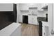 Clean kitchen featuring white cabinets and modern black appliances at 516 Caprice Ct, Raleigh, NC 27606