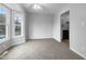 Bright living room featuring carpet, a ceiling fan, and a bay window at 516 Caprice Ct, Raleigh, NC 27606