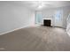 A large, empty living room with light-colored walls and carpet at 516 Caprice Ct, Raleigh, NC 27606